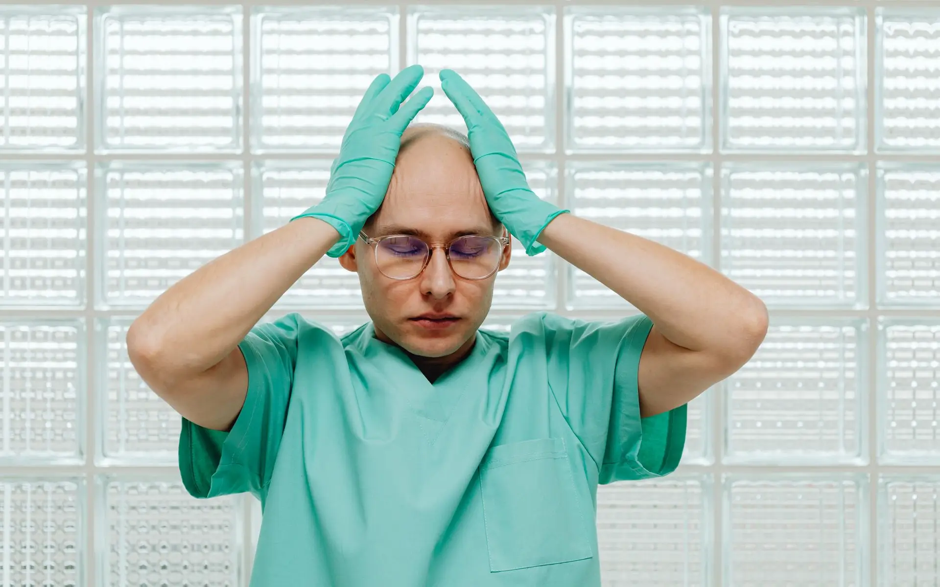 Exhausted healthcare worker in scrubs — warning signs of caregiver burnout
